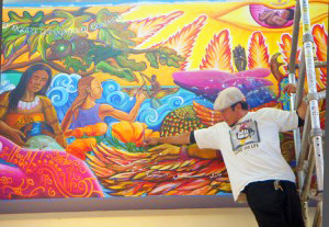 Arturo Avila, working on the Berkeley City College “Night” mural